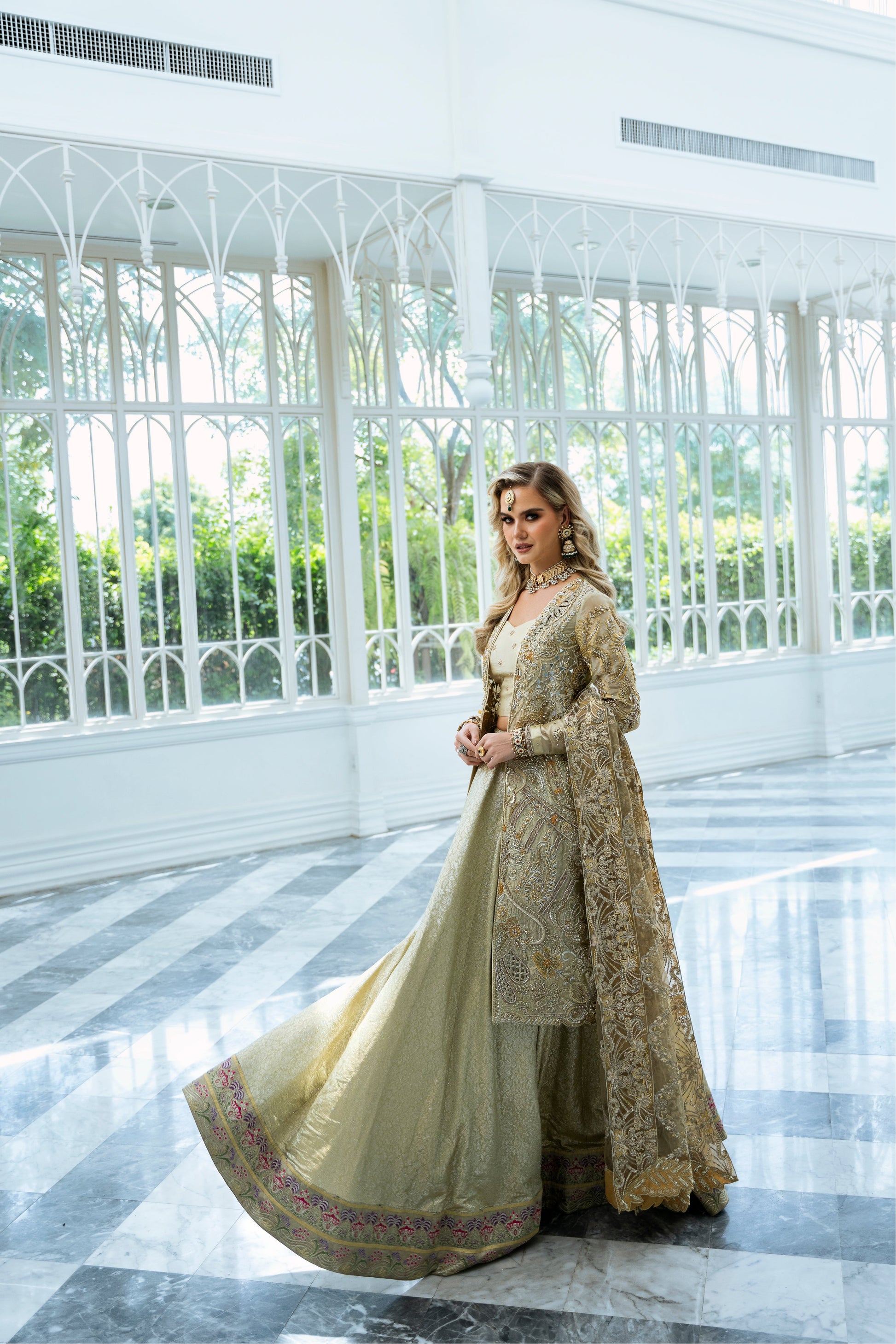Model wearing Marigold from Mysie by Tahira, a golden-hued ensemble with intricate embroidery, ideal for Pakistani luxury pret in the UK.
