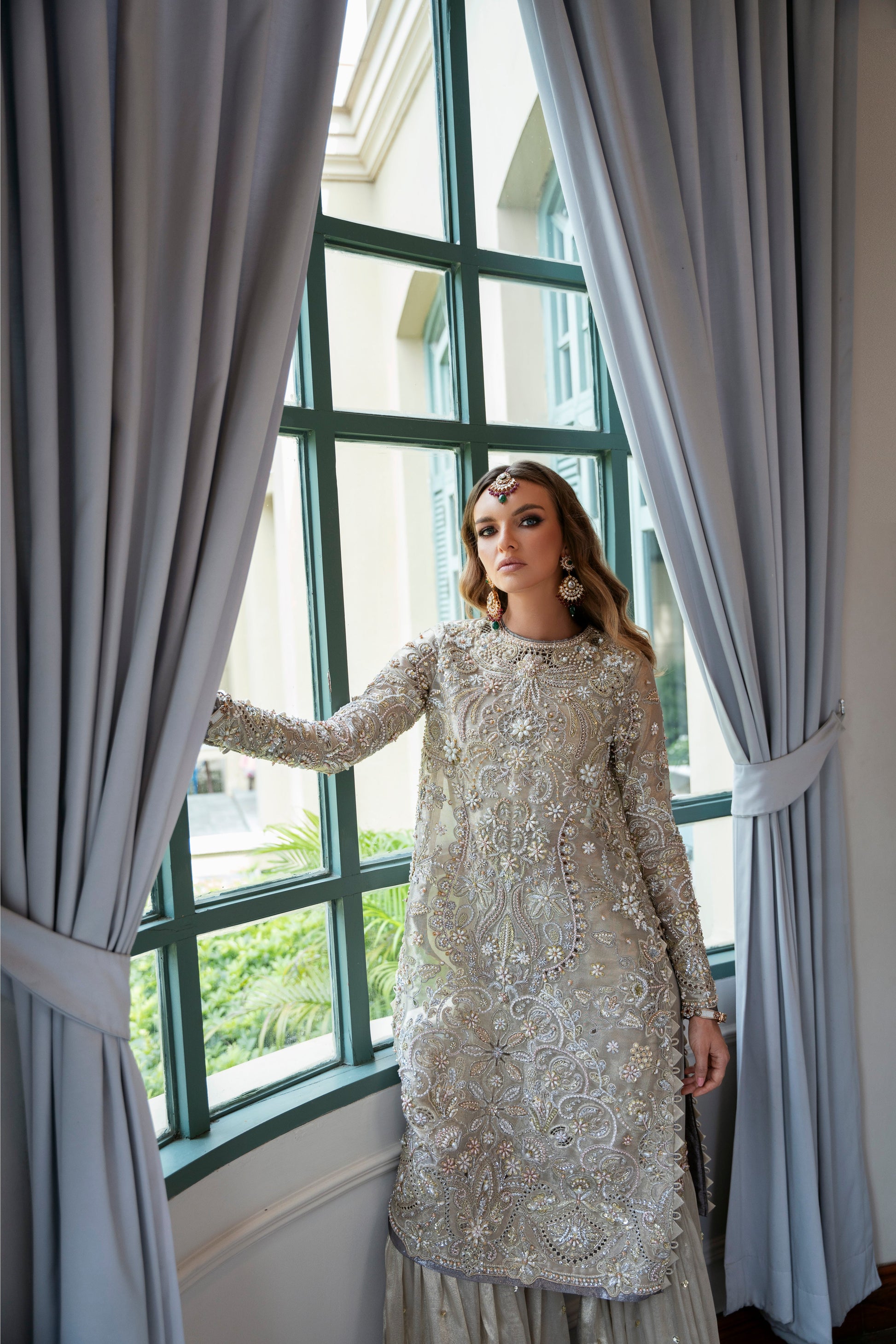 Model wearing Arya from Mysie by Tahira in beige with intricate embellishments, perfect for Pakistani luxury pret in the UK.