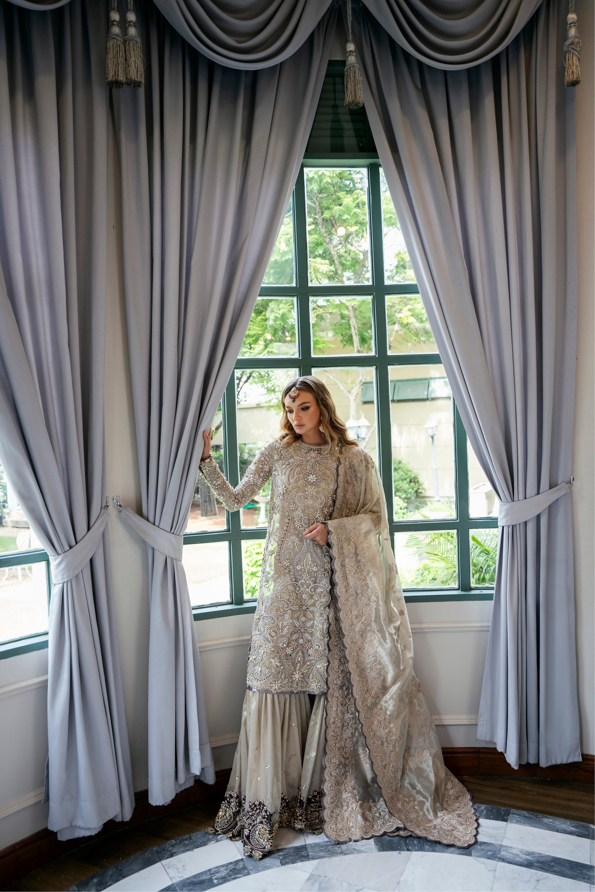 Model wearing Arya from Mysie by Tahira in beige with intricate embellishments, perfect for Pakistani luxury pret in the UK.