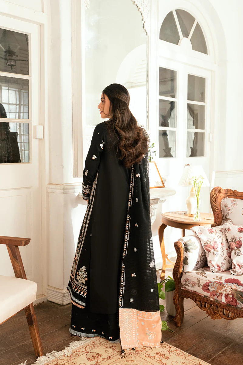 Model wearing black Qalamkar SB-03 Misha embroidered suit with peach accents, ideal for Eid and Pakistani luxury pret online in UK.