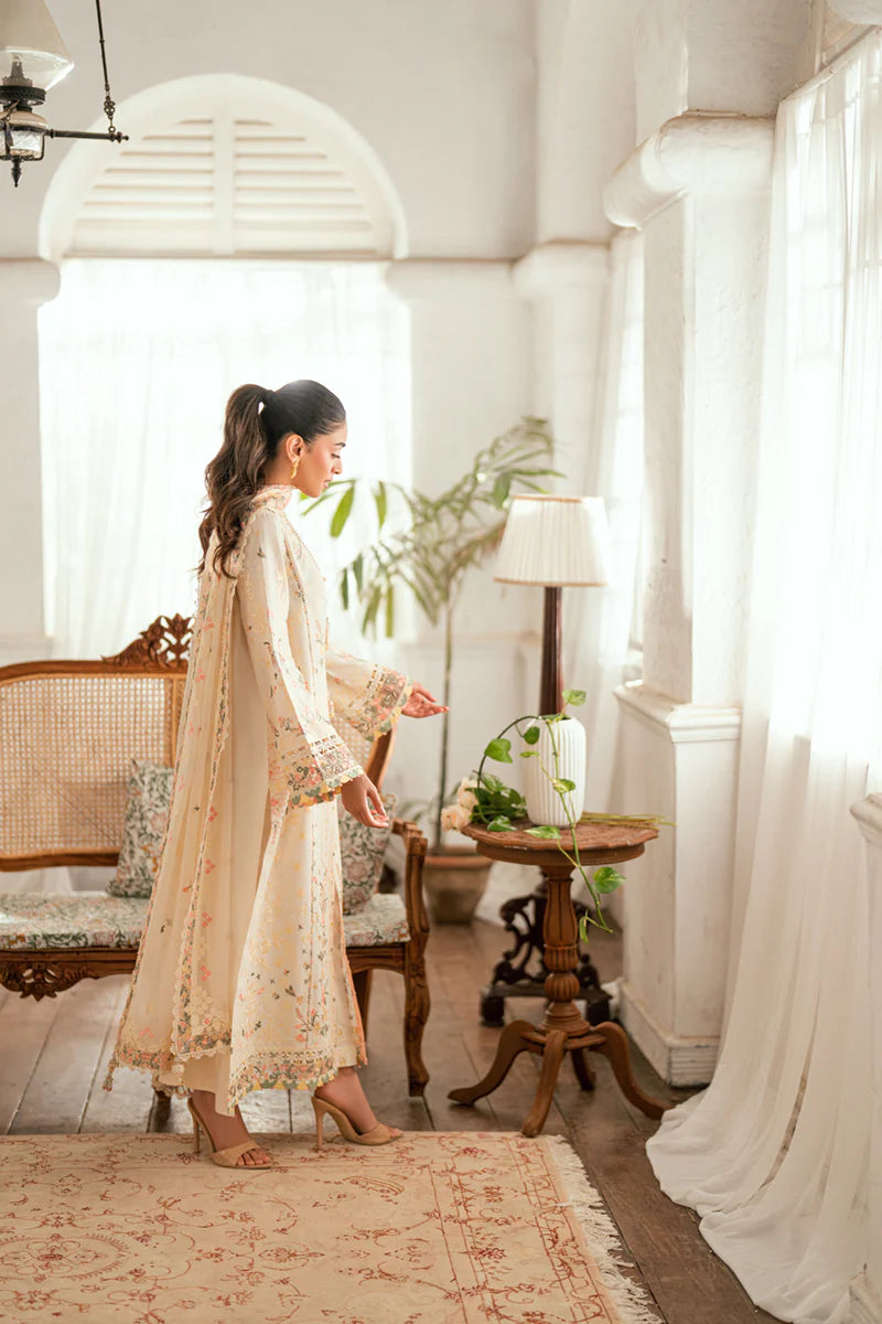 Model wearing ivory Qalamkar SB-01 Rina embroidered suit with pastel floral detailing, perfect for Eid and Pakistani luxury pret in UK.