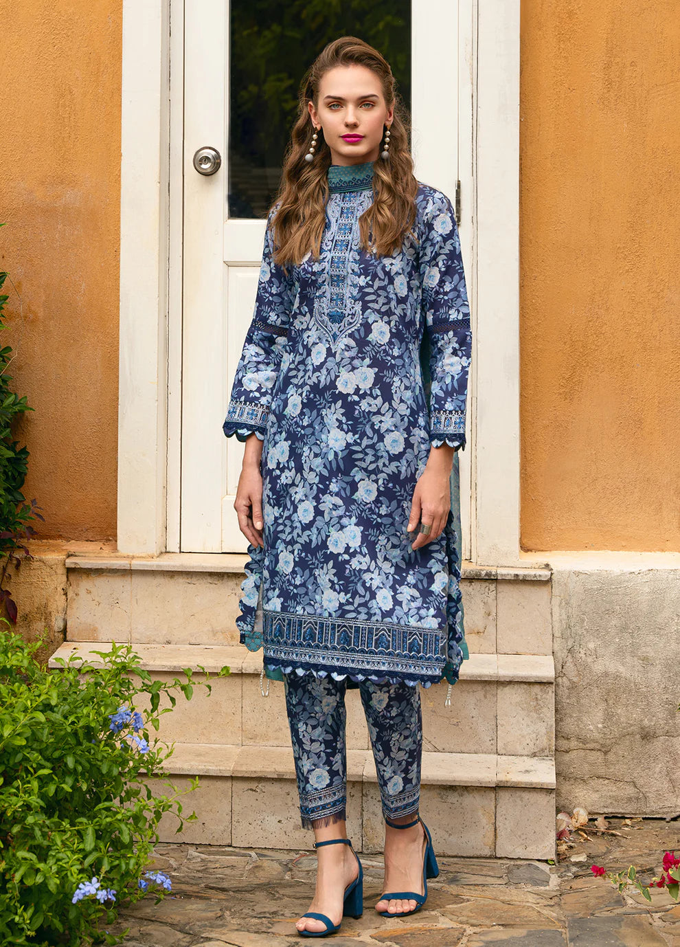 Model in Gulaal OLVERA, floral Pakistani attire, UK fashion must - have.