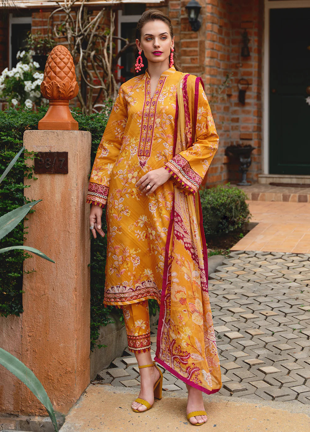 Model in Gulaal FLORENCE, vibrant Pakistani outfit, a UK fashion highlight.