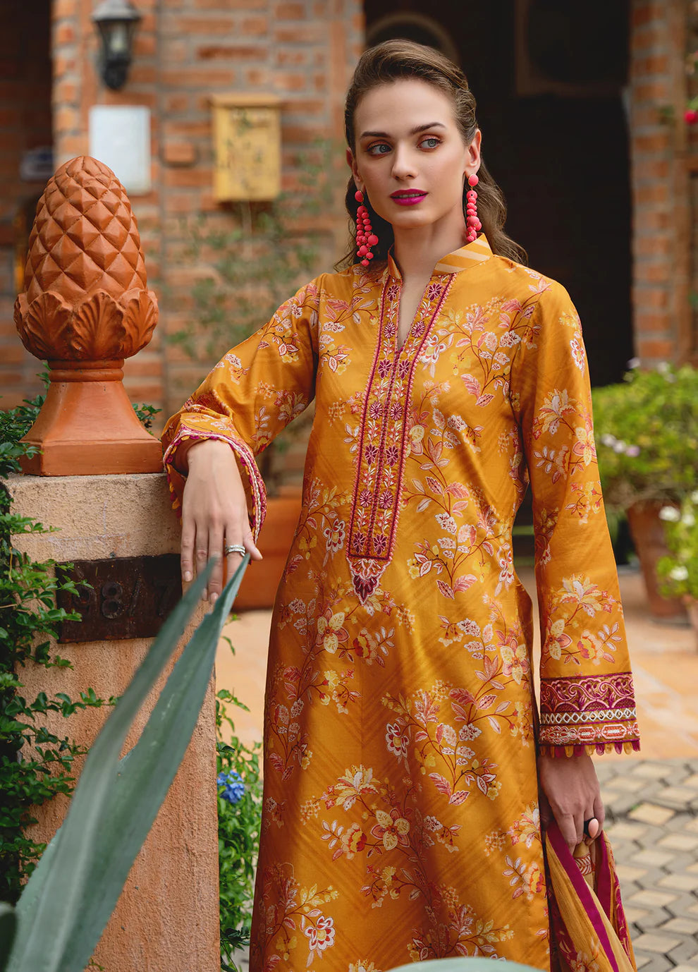 Model in Gulaal FLORENCE, vibrant Pakistani outfit, a UK fashion highlight.