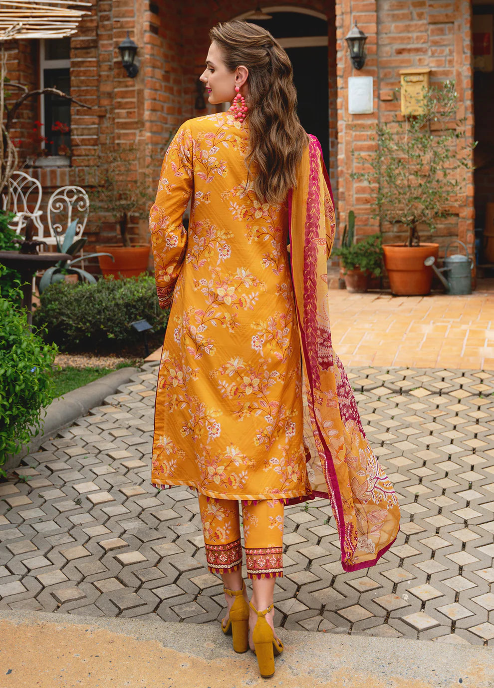 Model in Gulaal FLORENCE, vibrant Pakistani outfit, a UK fashion highlight.