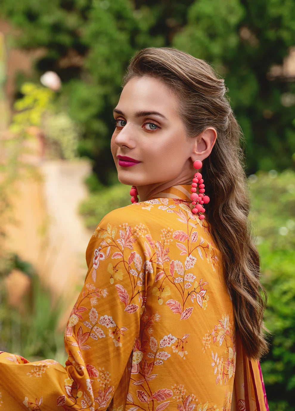 Model in Gulaal FLORENCE, vibrant Pakistani outfit, a UK fashion highlight.