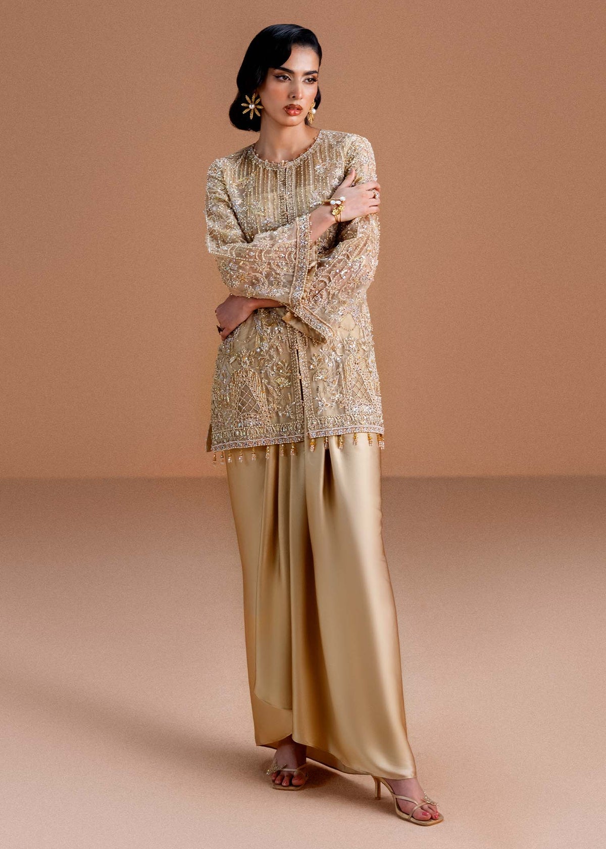 Model wearing gold Aurelia outfit from Kanwal Malik, perfect for Pakistani luxury pret and Pakistani clothes online in UK.
