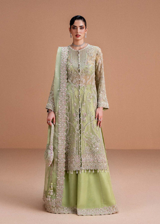 Model wearing pistachio green Sila outfit from Kanwal Malik, adorned with delicate embroidery for Pakistani luxury pret and clothes online in UK.