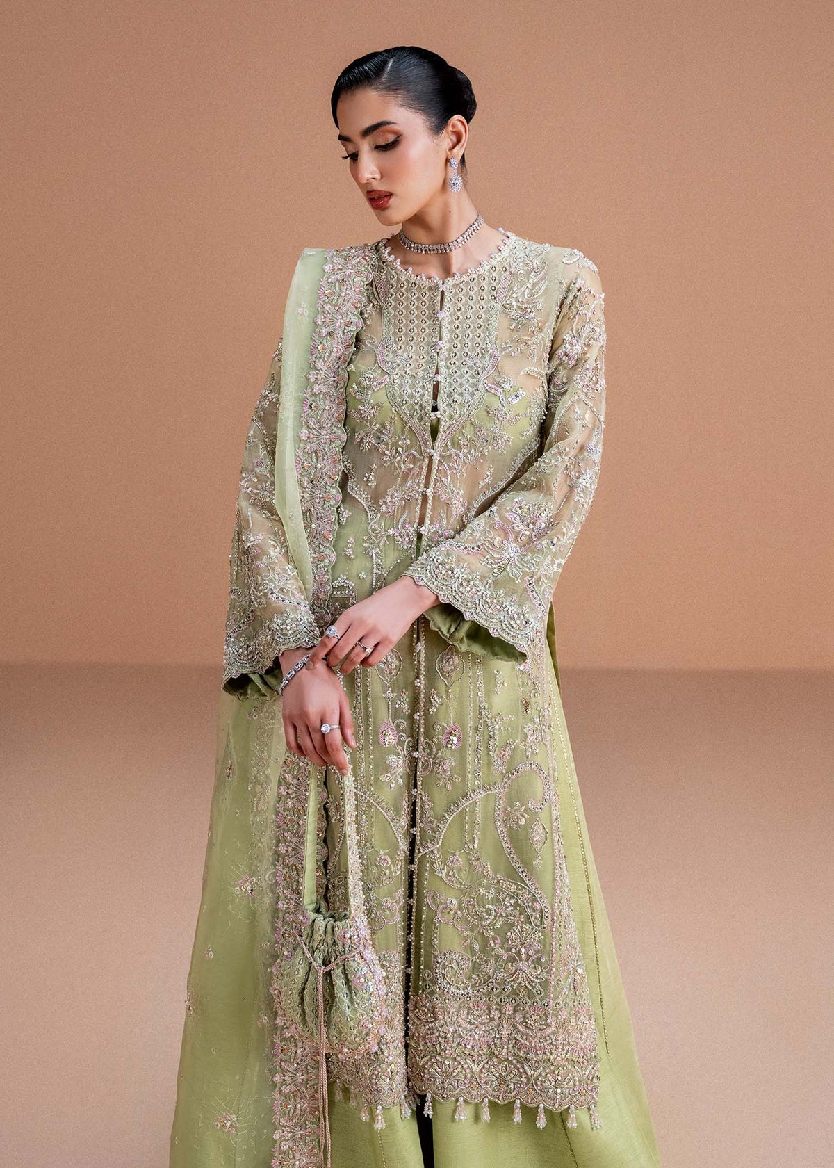 Model wearing pistachio green Sila outfit from Kanwal Malik, adorned with delicate embroidery for Pakistani luxury pret and clothes online in UK.