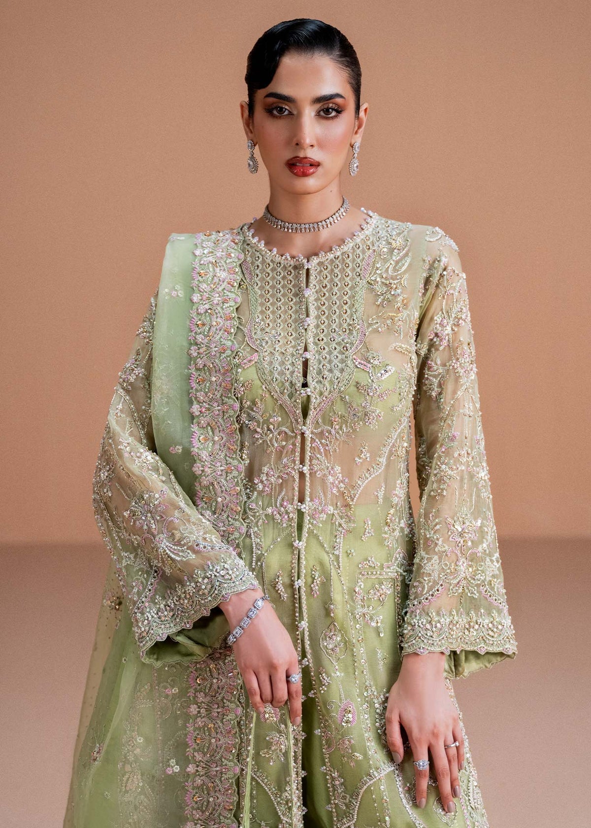 Model wearing pistachio green Sila outfit from Kanwal Malik, adorned with delicate embroidery for Pakistani luxury pret and clothes online in UK.