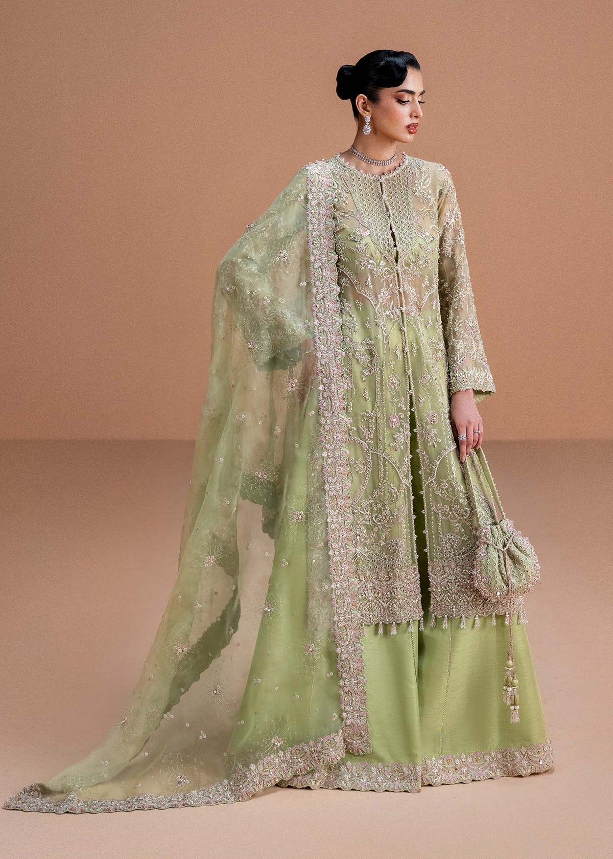 Model wearing pistachio green Sila outfit from Kanwal Malik, adorned with delicate embroidery for Pakistani luxury pret and clothes online in UK.