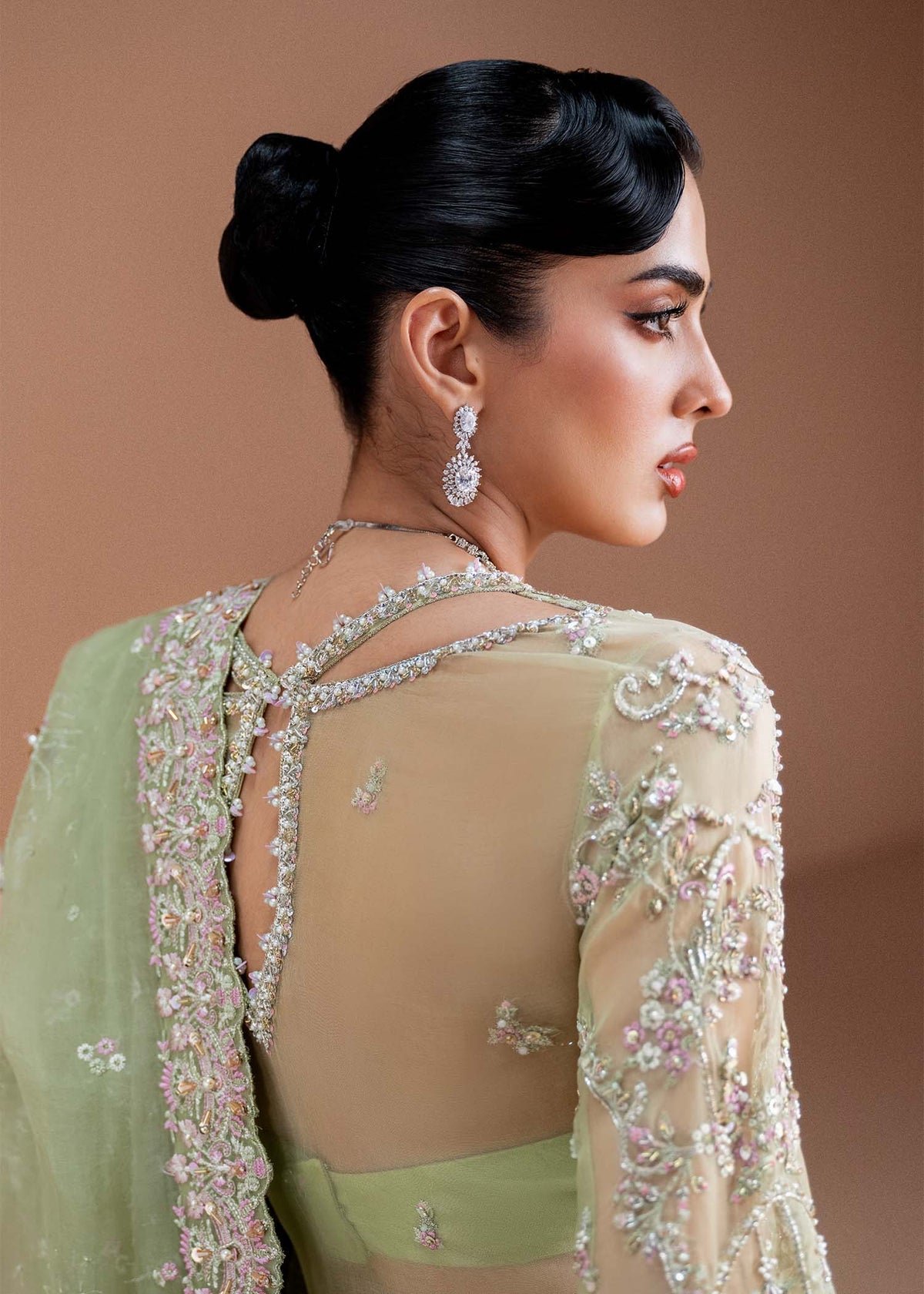 Model wearing pistachio green Sila outfit from Kanwal Malik, adorned with delicate embroidery for Pakistani luxury pret and clothes online in UK.