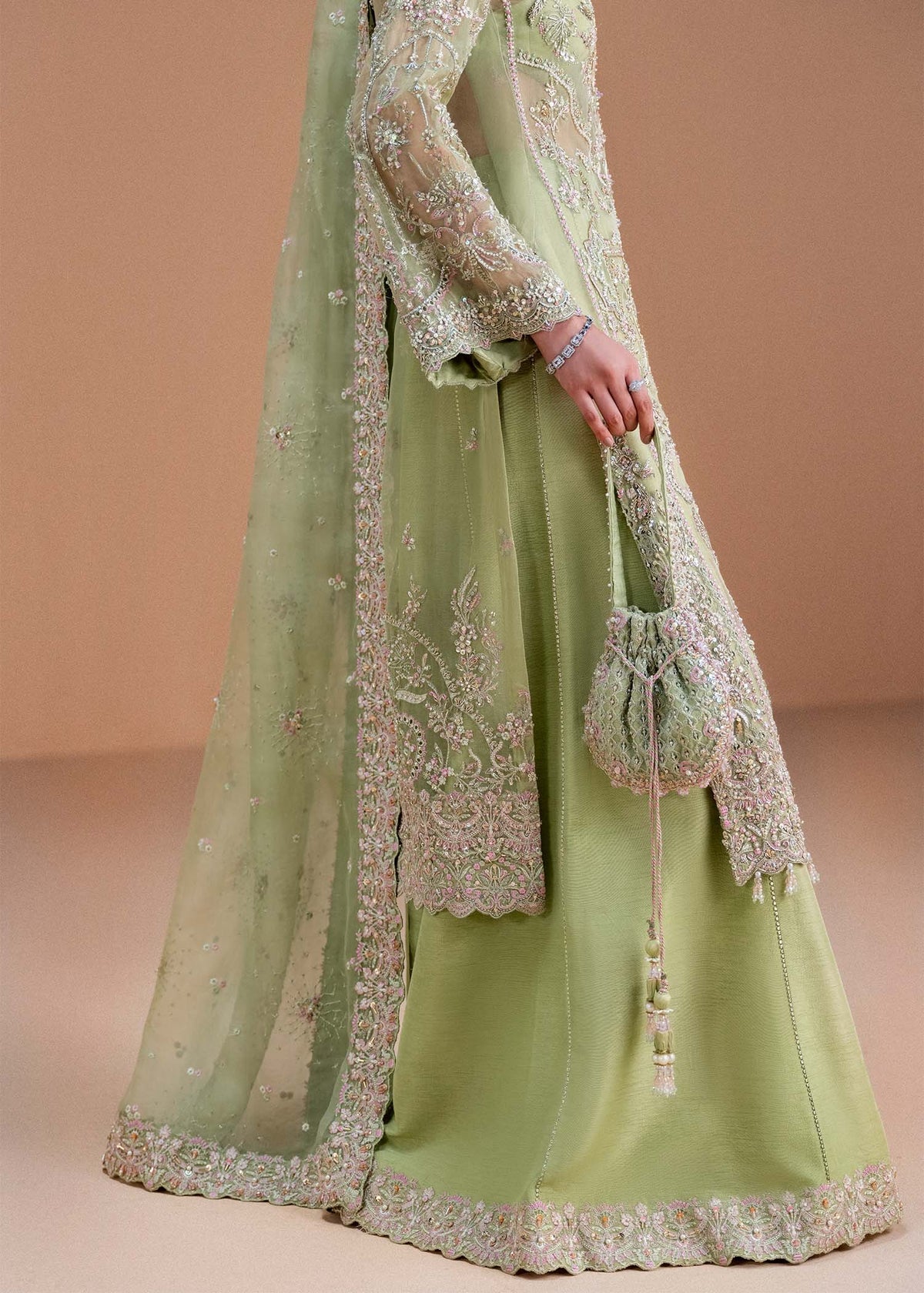 Model wearing pistachio green Sila outfit from Kanwal Malik, adorned with delicate embroidery for Pakistani luxury pret and clothes online in UK.