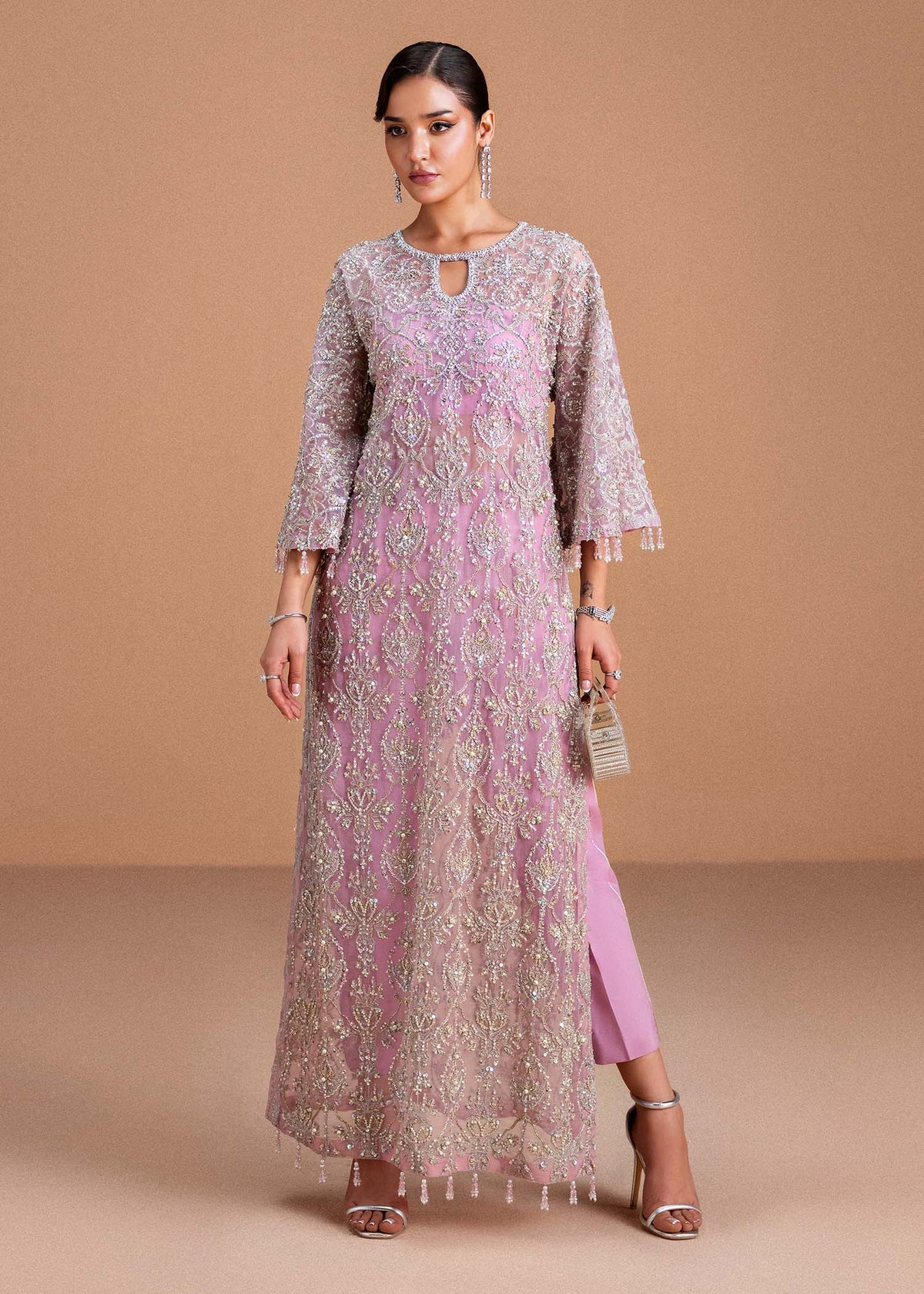 Model wearing blush pink Dina outfit from Kanwal Malik, showcasing intricate handwork for Pakistani luxury pret and clothes online in UK.
