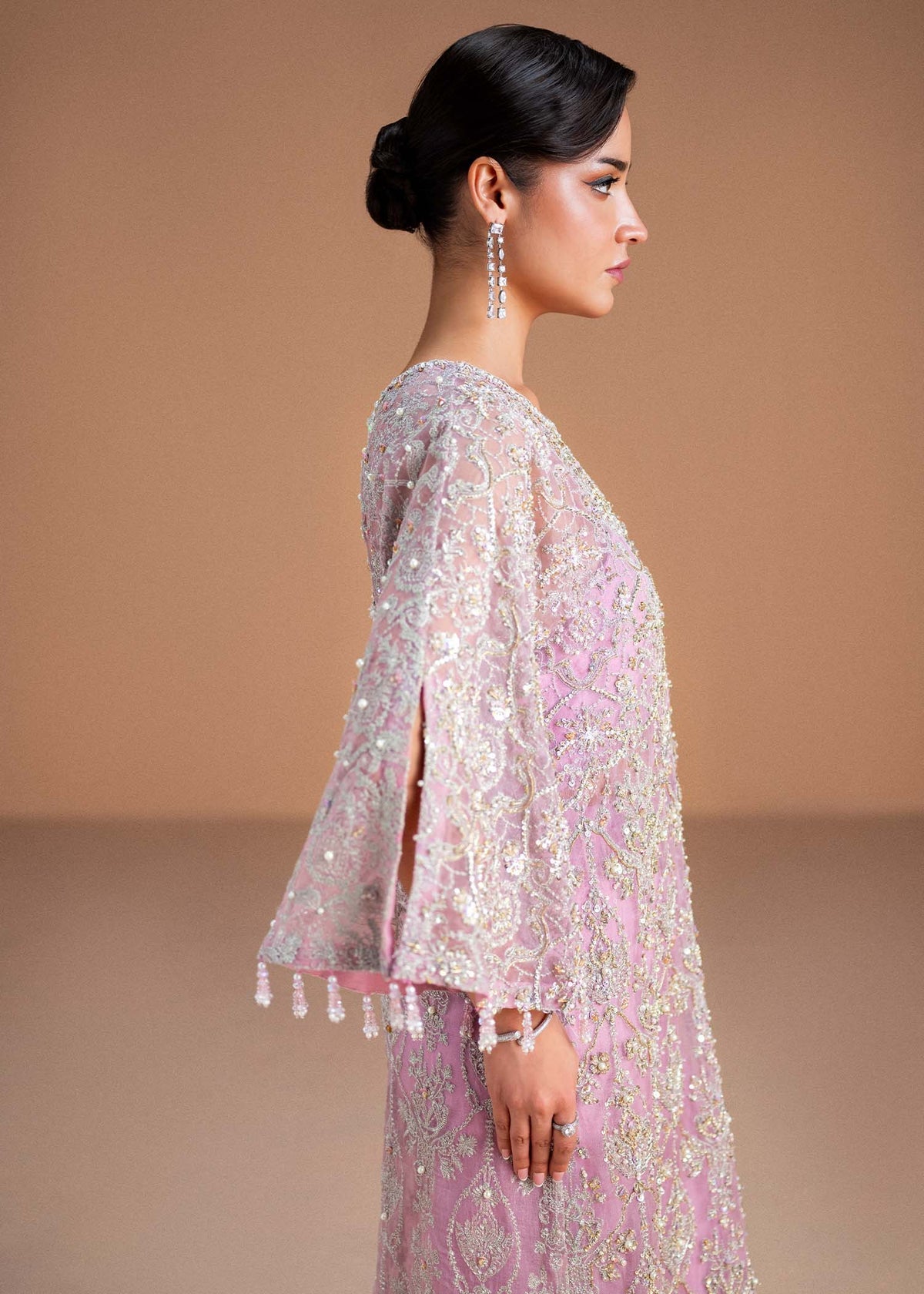 Model wearing blush pink Dina outfit from Kanwal Malik, showcasing intricate handwork for Pakistani luxury pret and clothes online in UK.
