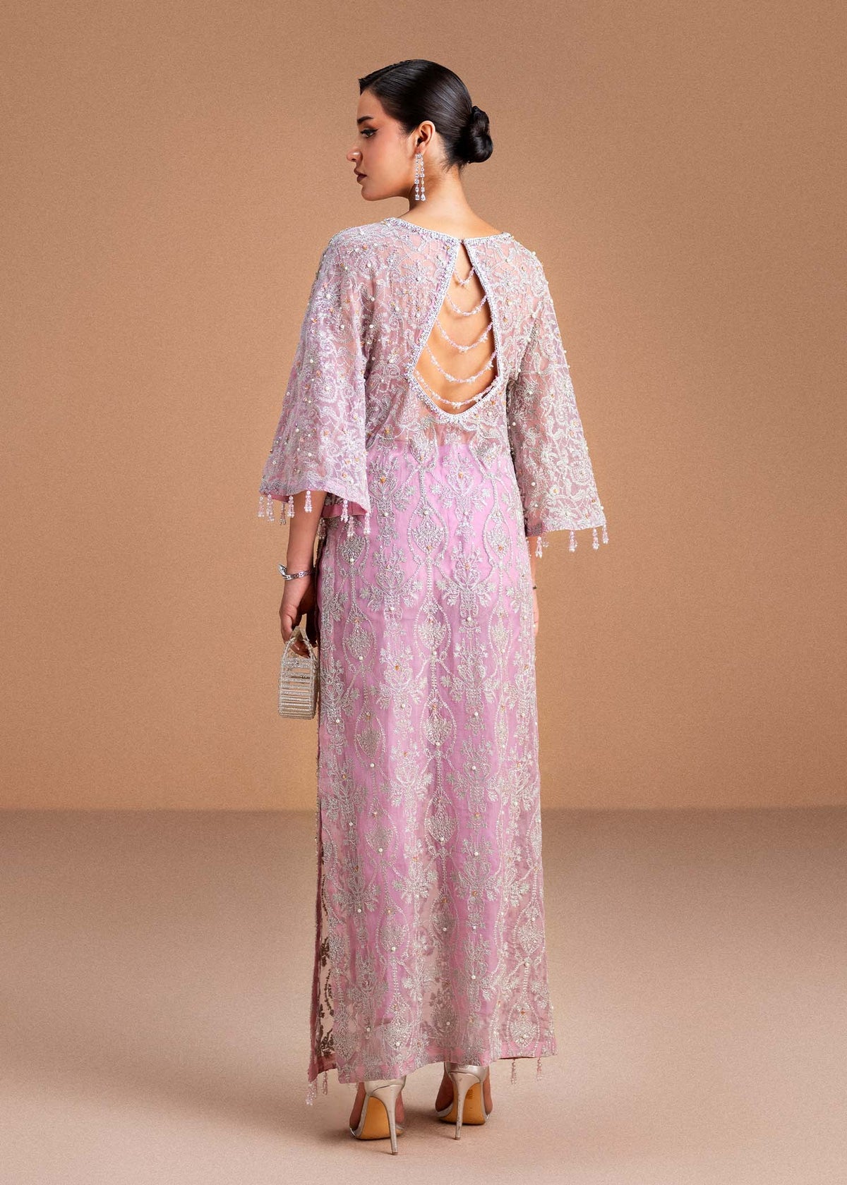 Model wearing blush pink Dina outfit from Kanwal Malik, showcasing intricate handwork for Pakistani luxury pret and clothes online in UK.
