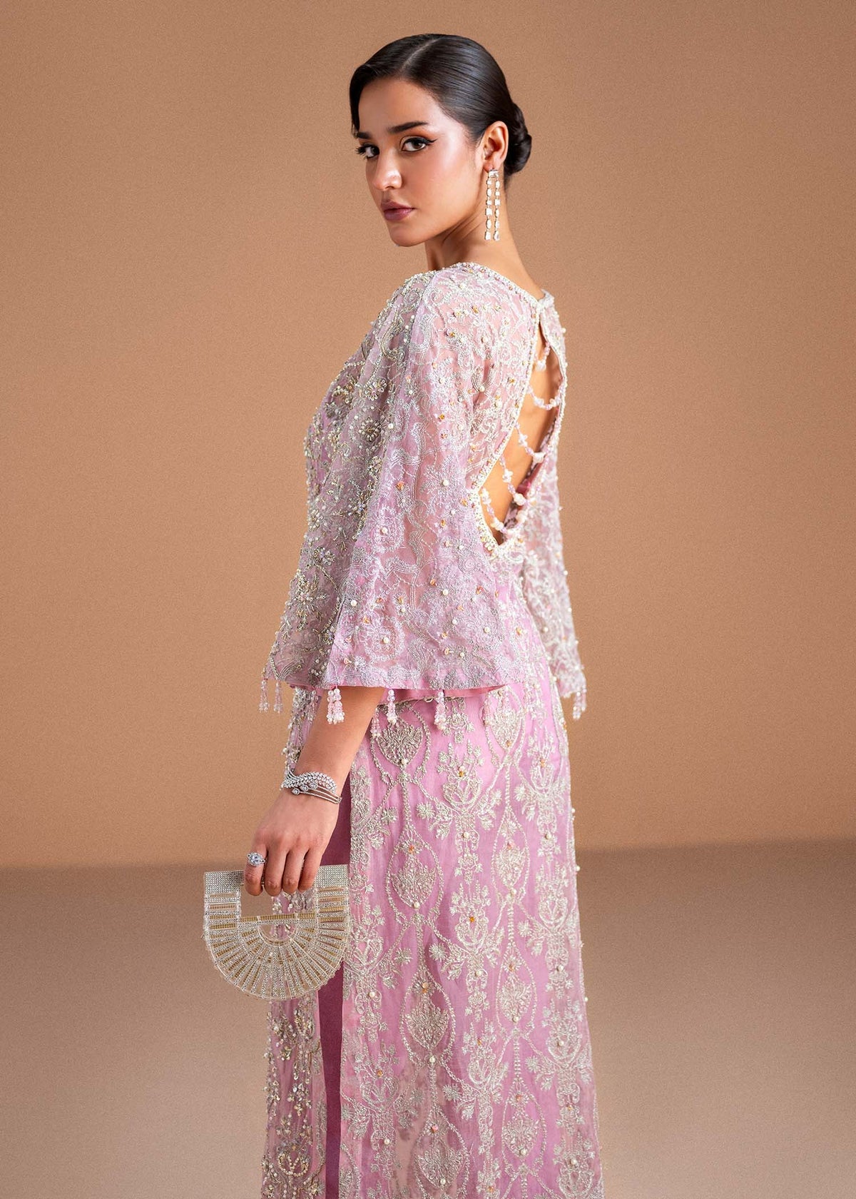 Model wearing blush pink Dina outfit from Kanwal Malik, showcasing intricate handwork for Pakistani luxury pret and clothes online in UK.
