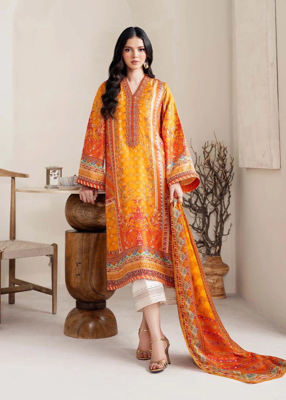 Model wearing bright orange printed Maesha from Kanwal Malik Rosalia Silk Eid Collection '25, Pakistani luxury pret online in UK.