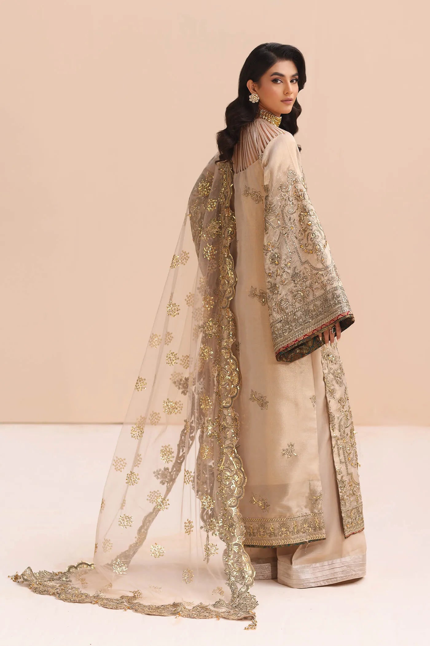 Model in gold Musferah Saad Divine Princess Pakistani wedding attire, UK.