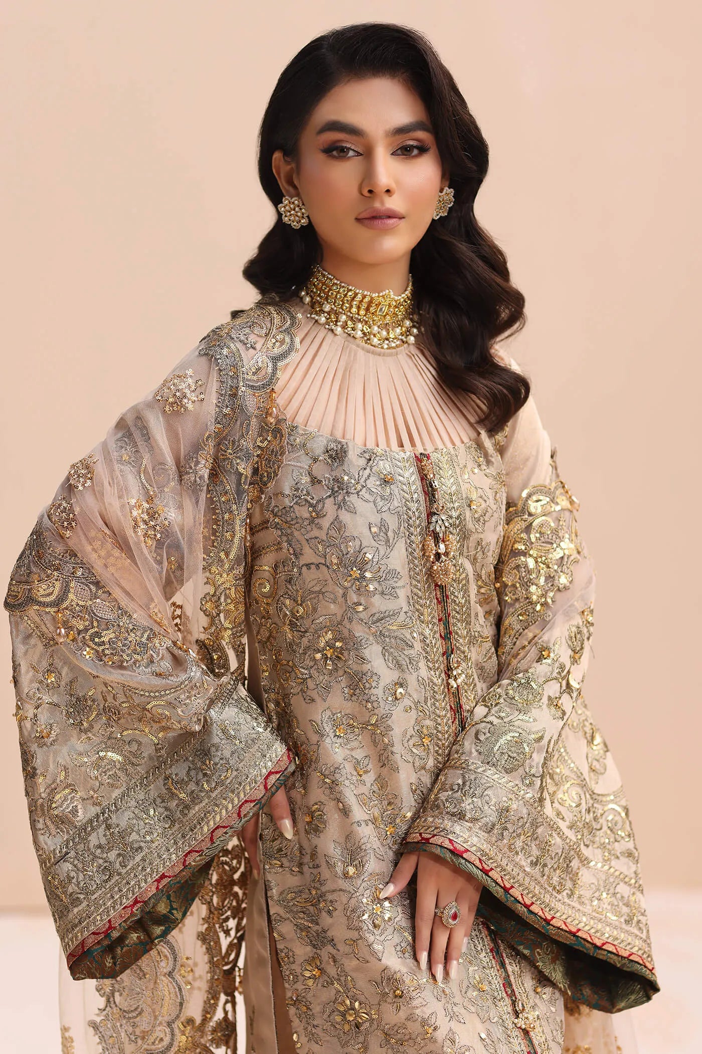 Model in gold Musferah Saad Divine Princess Pakistani wedding attire, UK.