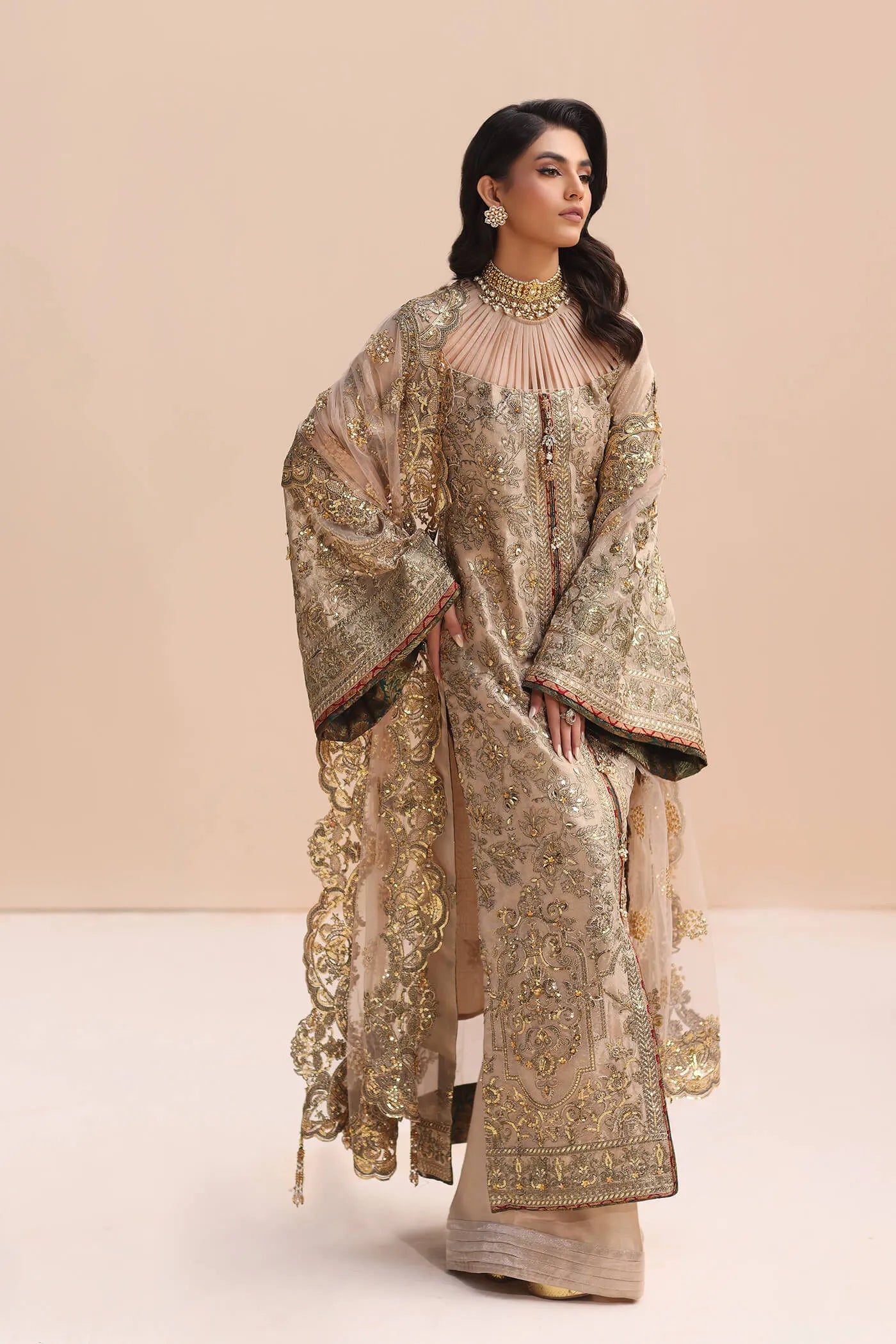 Model in gold Musferah Saad Divine Princess Pakistani wedding attire, UK.