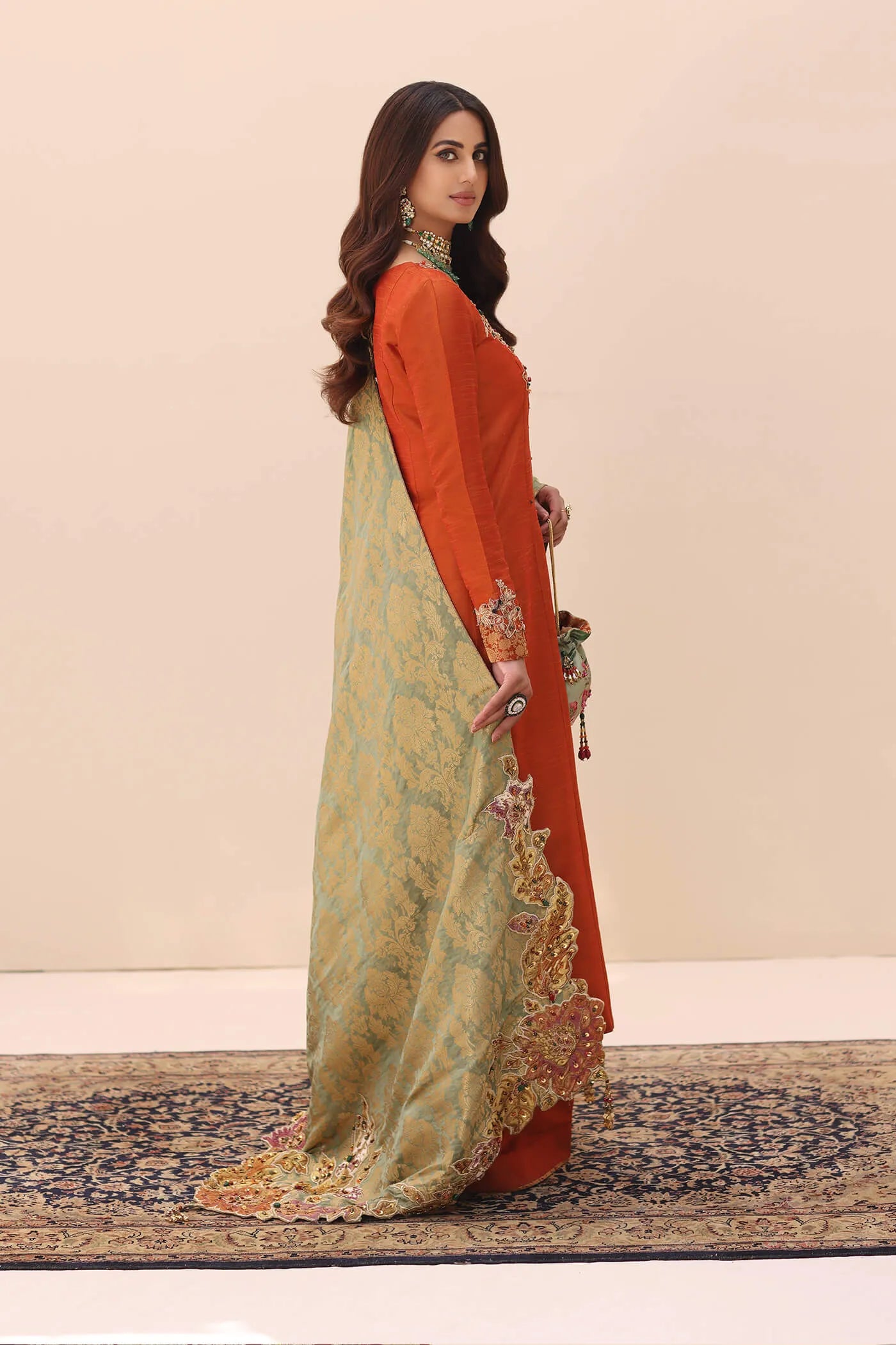 Model wearing Ethereal Embrace Shawl Collection's TANGERINE AURA SHAWLL, an equisite mold by Musferah Saad UK, Pakistani Clothes UK.