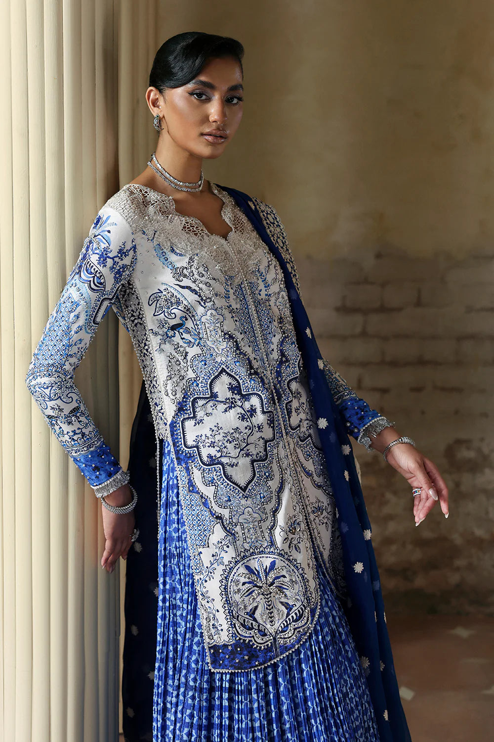 Model wearing Evadia by Soraya in ivory and royal blue printed outfit – Pakistani luxury pret available online in UK for festive wear.
