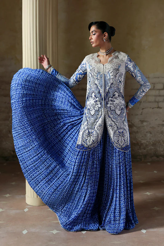 Model wearing Evadia by Soraya in ivory and royal blue printed outfit – Pakistani luxury pret available online in UK for festive wear.
