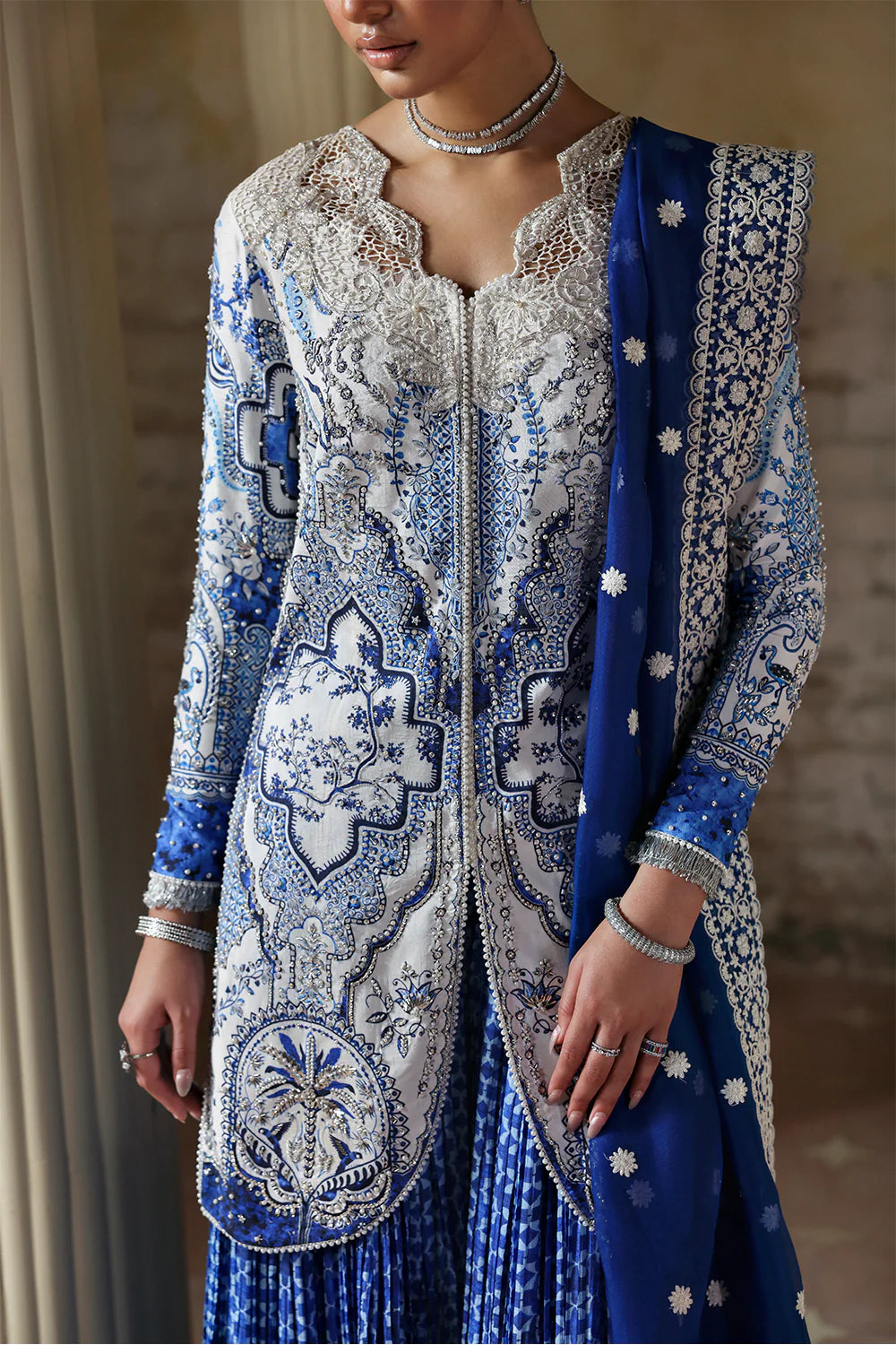 Model wearing Evadia by Soraya in ivory and royal blue printed outfit – Pakistani luxury pret available online in UK for festive wear.
