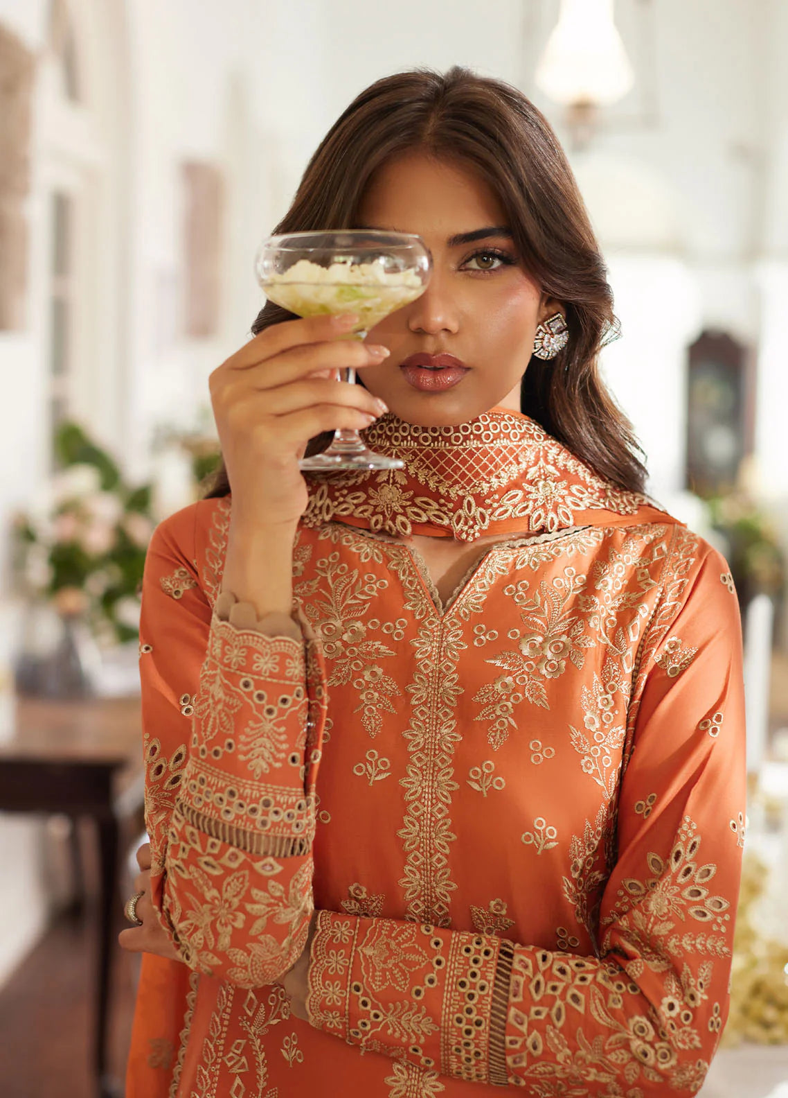Model wearing rust orange Solara from Gulaal Lumiere Chikankaari Lawn, Pakistani luxury pret and Pakistani clothes online in UK.