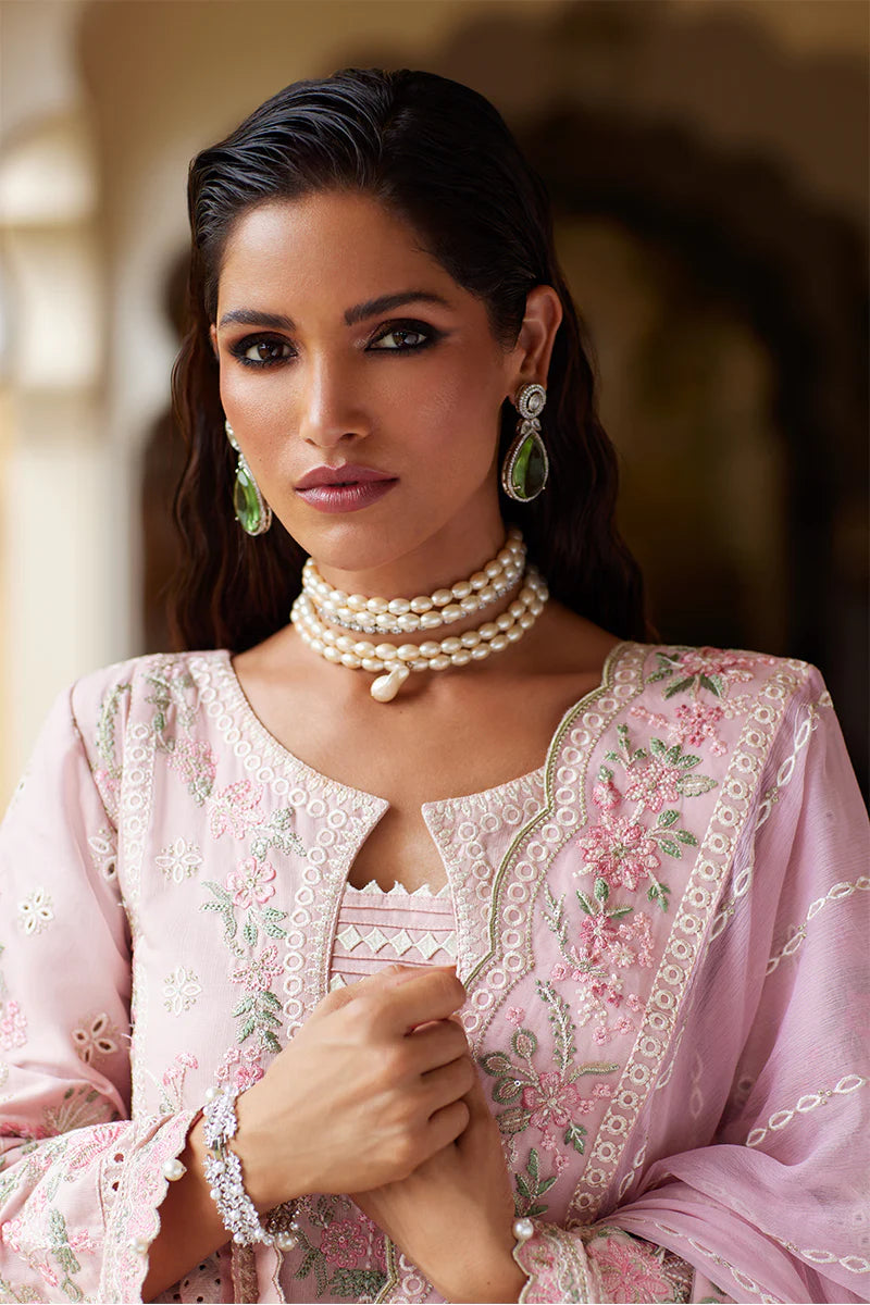 Model wearing Gulaal MAGNOLIA pink luxury lawn dress with delicate embroidery. Shop Pakistani luxury pret online in the UK for elegant fashion.