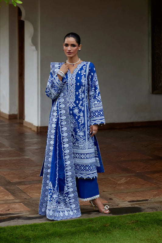 Model wearing Gulaal CYNARA royal blue luxury lawn dress with intricate white embroidery. Shop Pakistani luxury pret online in the UK.