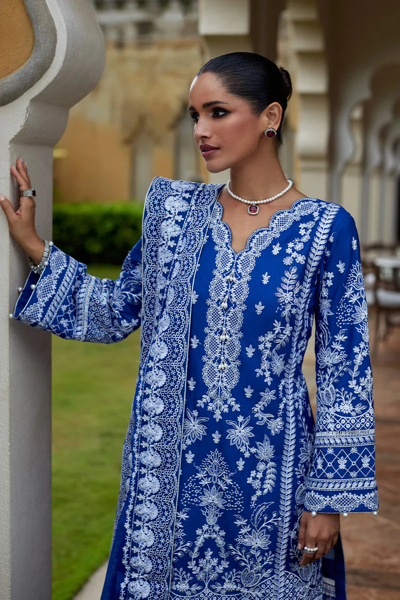 Model wearing Gulaal CYNARA royal blue luxury lawn dress with intricate white embroidery. Shop Pakistani luxury pret online in the UK.