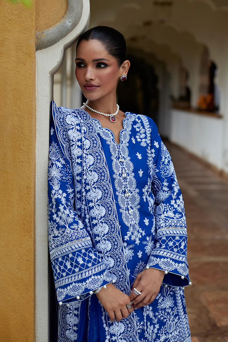 Model wearing Gulaal CYNARA royal blue luxury lawn dress with intricate white embroidery. Shop Pakistani luxury pret online in the UK.