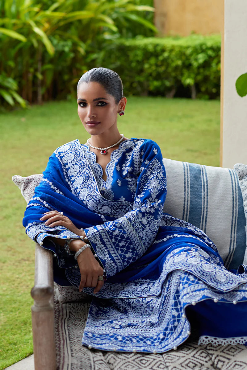 Model wearing Gulaal CYNARA royal blue luxury lawn dress with intricate white embroidery. Shop Pakistani luxury pret online in the UK.