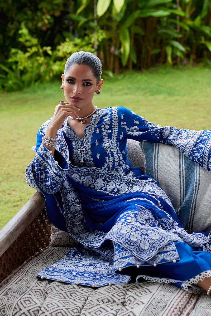 Model wearing Gulaal CYNARA royal blue luxury lawn dress with intricate white embroidery. Shop Pakistani luxury pret online in the UK.