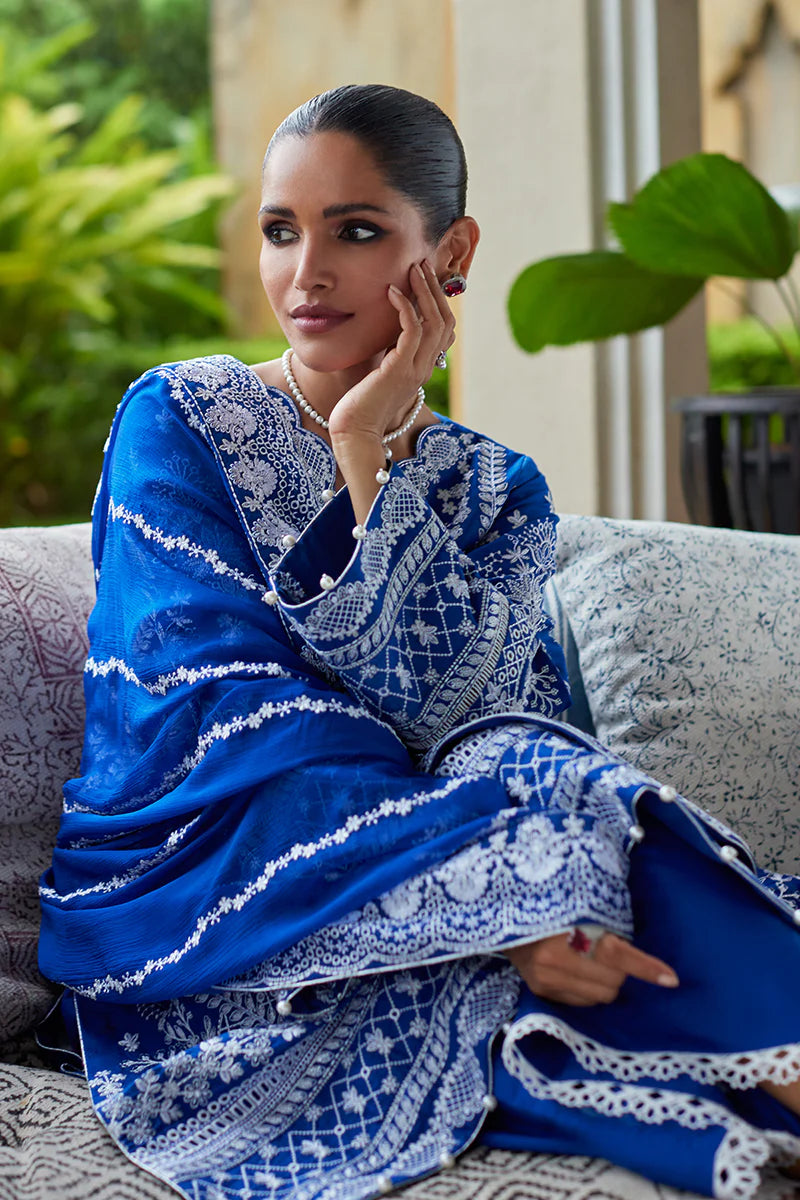 Model wearing Gulaal CYNARA royal blue luxury lawn dress with intricate white embroidery. Shop Pakistani luxury pret online in the UK.