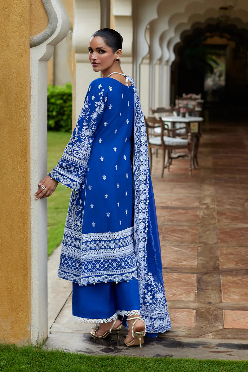 Model wearing Gulaal CYNARA royal blue luxury lawn dress with intricate white embroidery. Shop Pakistani luxury pret online in the UK.