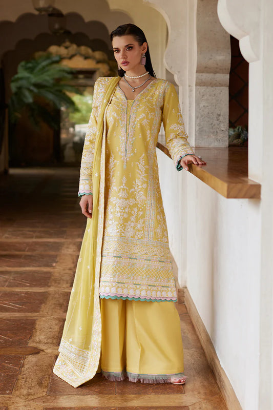 Model wearing Gulaal IRIS mustard yellow luxury lawn dress with delicate white embroidery. Shop Pakistani luxury pret online in the UK.