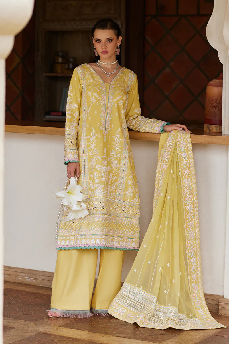 Model wearing Gulaal IRIS mustard yellow luxury lawn dress with delicate white embroidery. Shop Pakistani luxury pret online in the UK.