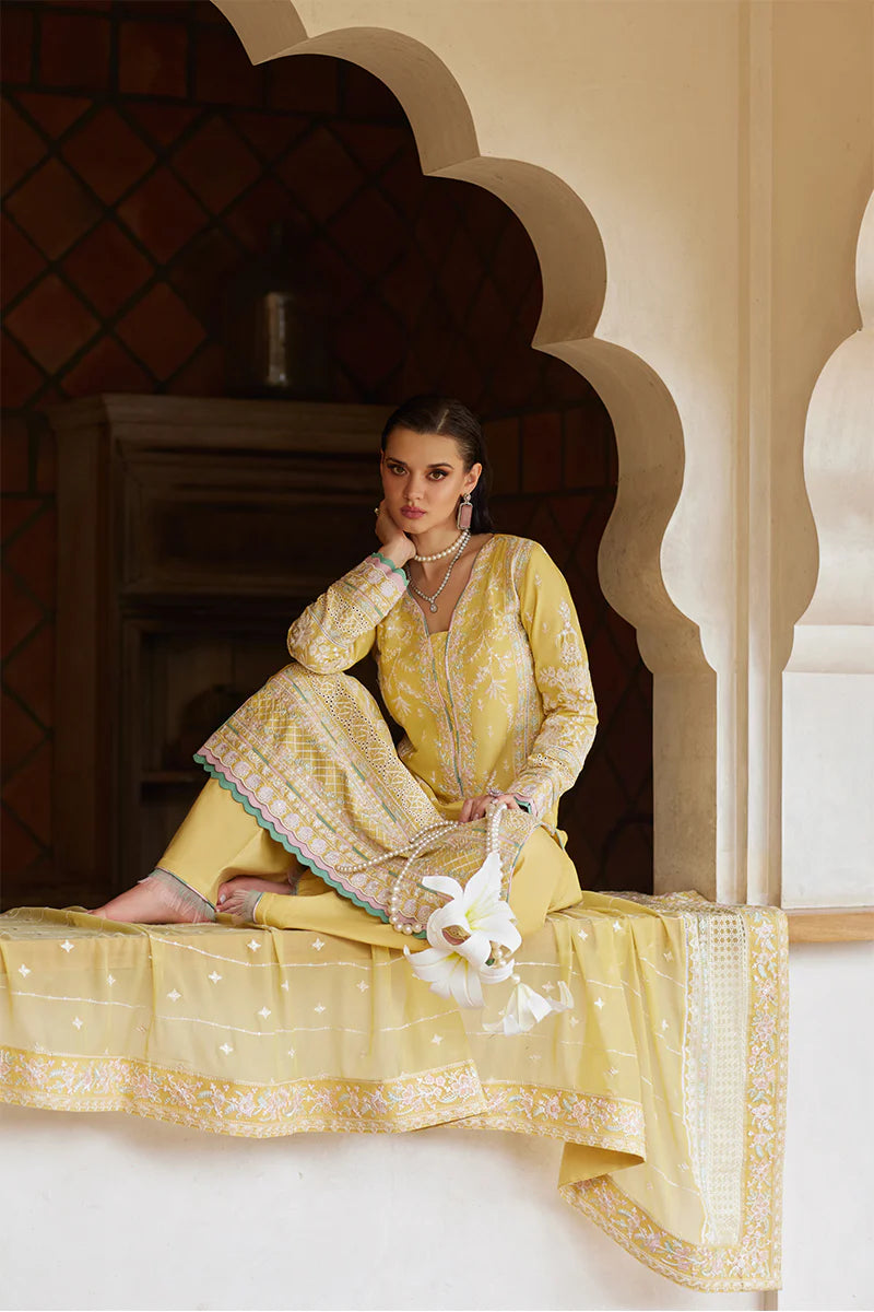 Model wearing Gulaal IRIS mustard yellow luxury lawn dress with delicate white embroidery. Shop Pakistani luxury pret online in the UK.