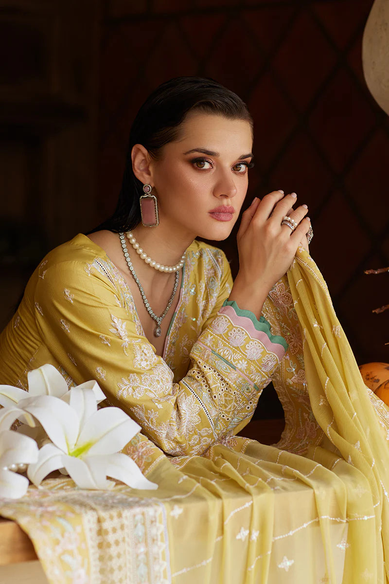 Model wearing Gulaal IRIS mustard yellow luxury lawn dress with delicate white embroidery. Shop Pakistani luxury pret online in the UK.