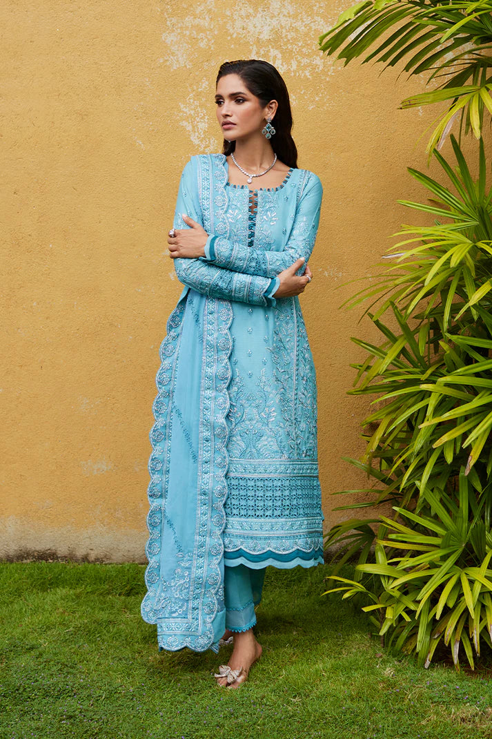 Model wearing Gulaal DHALIA turquoise blue luxury lawn dress with intricate embroidery. Shop Pakistani luxury pret online in the UK.