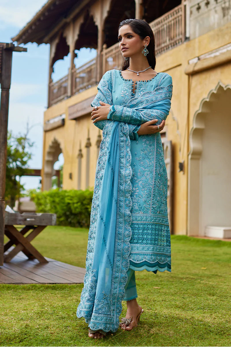 Model wearing Gulaal DHALIA turquoise blue luxury lawn dress with intricate embroidery. Shop Pakistani luxury pret online in the UK.