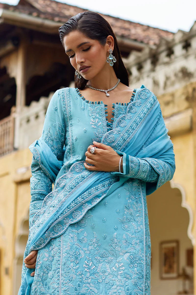 Model wearing Gulaal DHALIA turquoise blue luxury lawn dress with intricate embroidery. Shop Pakistani luxury pret online in the UK.