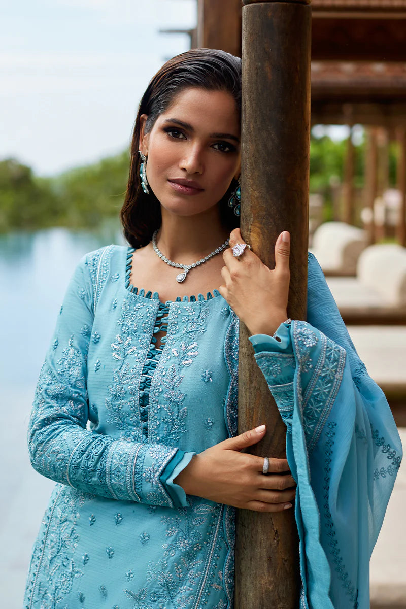 Model wearing Gulaal DHALIA turquoise blue luxury lawn dress with intricate embroidery. Shop Pakistani luxury pret online in the UK.