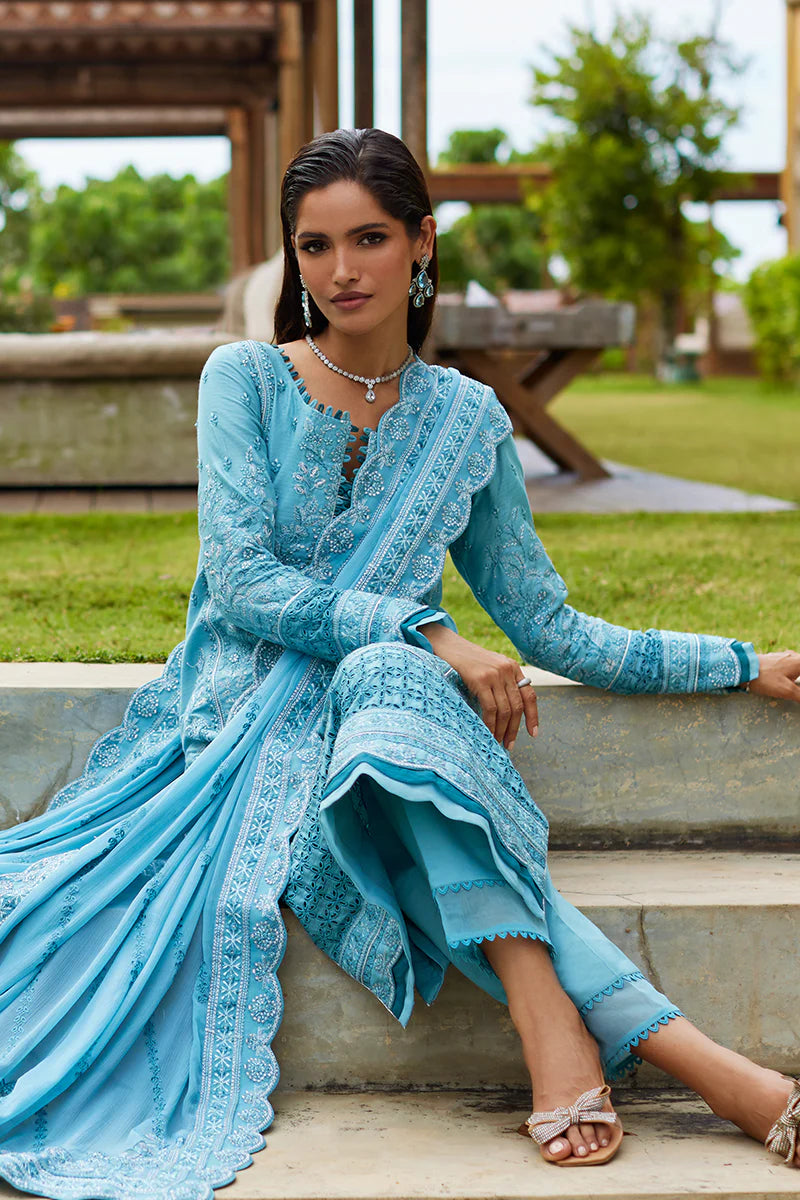 Model wearing Gulaal DHALIA turquoise blue luxury lawn dress with intricate embroidery. Shop Pakistani luxury pret online in the UK.