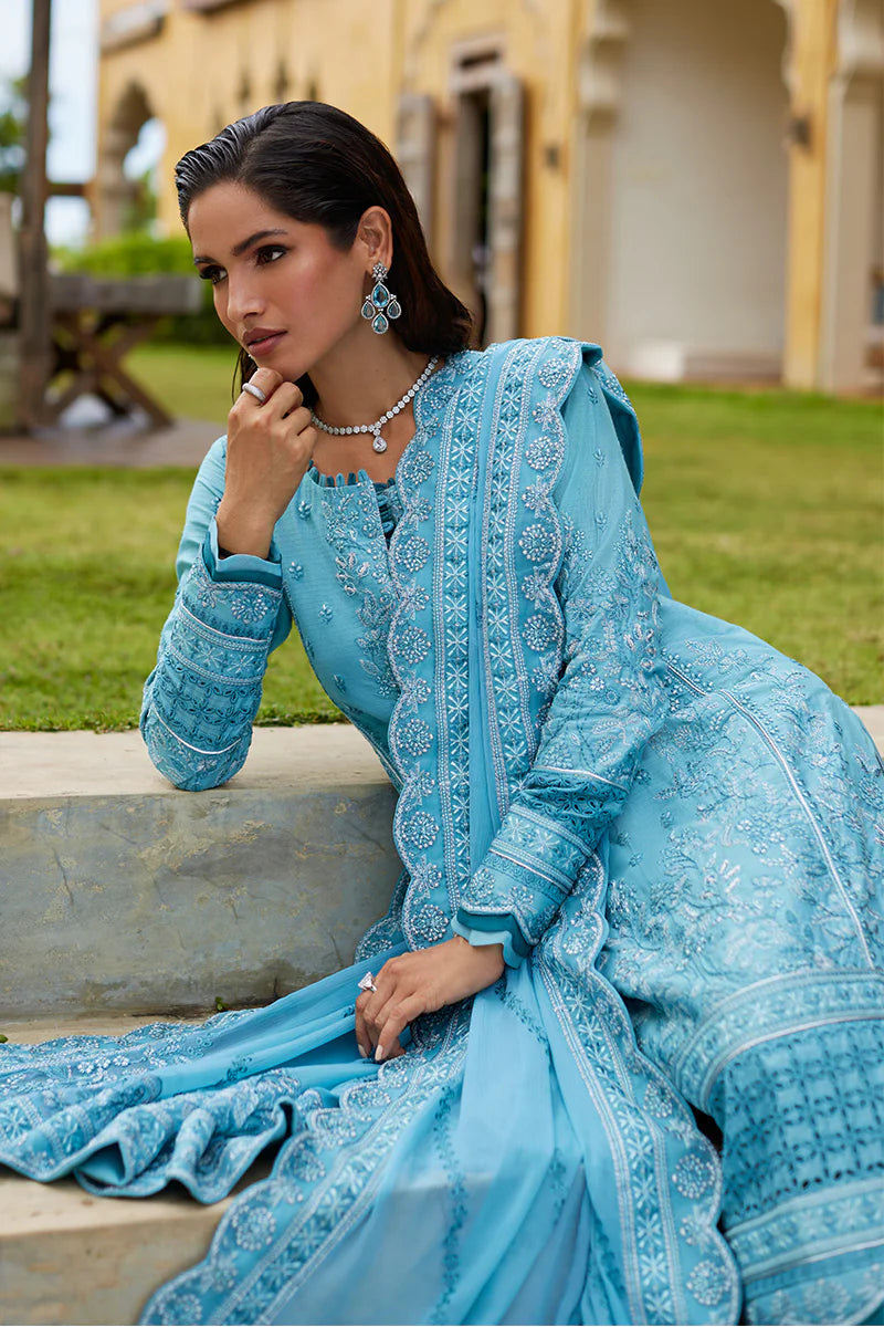 Model wearing Gulaal DHALIA turquoise blue luxury lawn dress with intricate embroidery. Shop Pakistani luxury pret online in the UK.