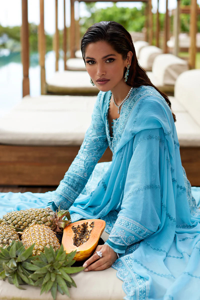 Model wearing Gulaal DHALIA turquoise blue luxury lawn dress with intricate embroidery. Shop Pakistani luxury pret online in the UK.