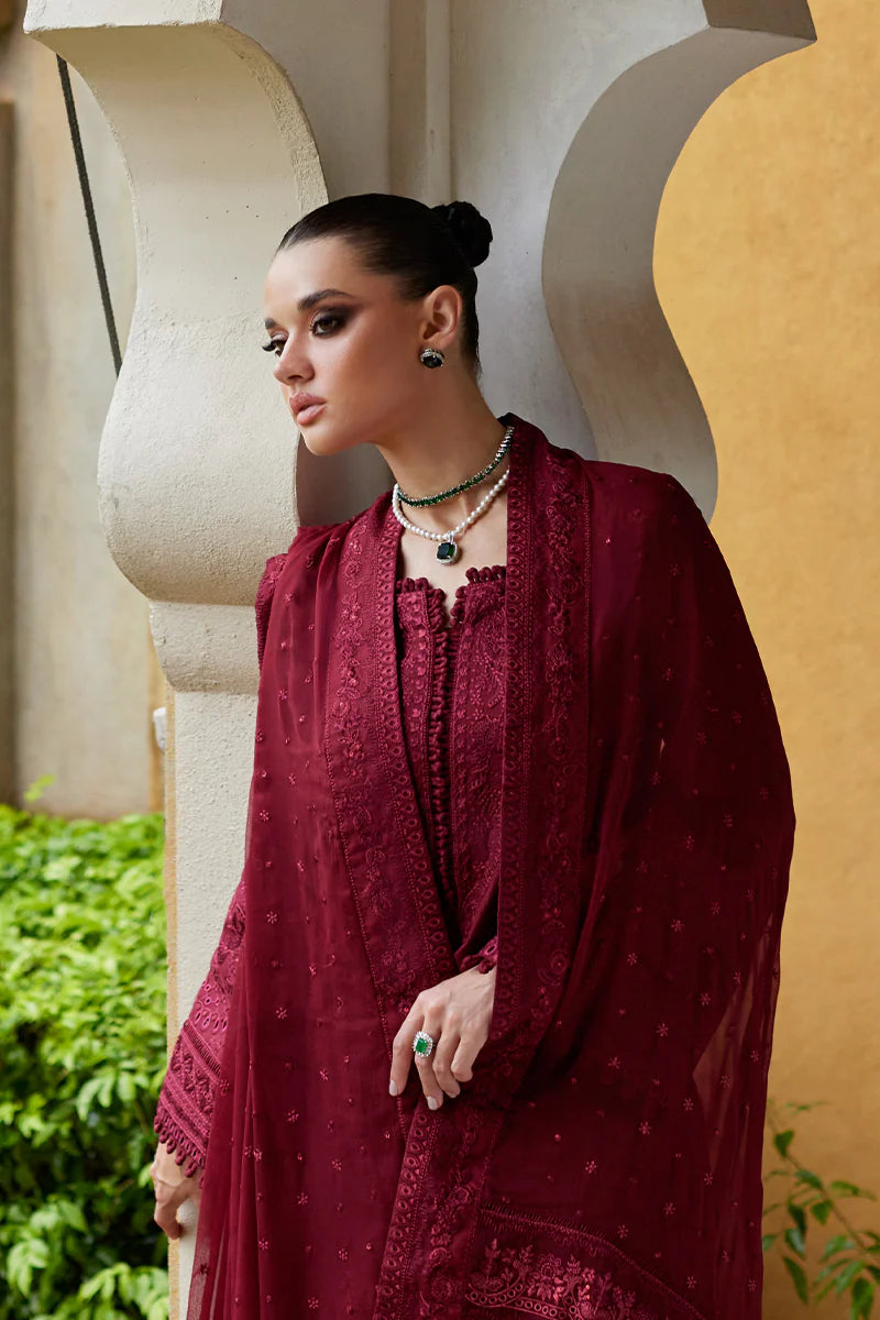 Model wearing Gulaal NIGELLA deep red luxury lawn dress with intricate embroidery. Shop Pakistani luxury pret online in the UK for an elegant look.